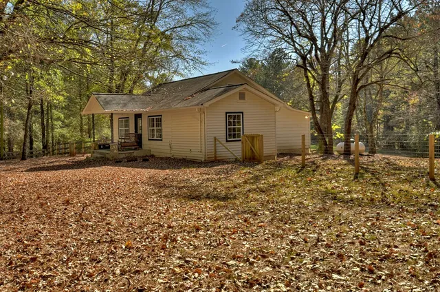 a backyard of a house with barbeque oven