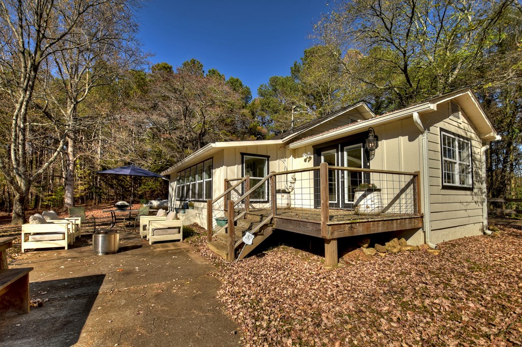 3380 Clear Creek Road Ellijay, GA 30536 - Photo 8 of 39 a white house that has a small yard and large trees