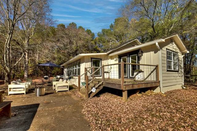 a view of a patio with table and chairs under an umbrella
