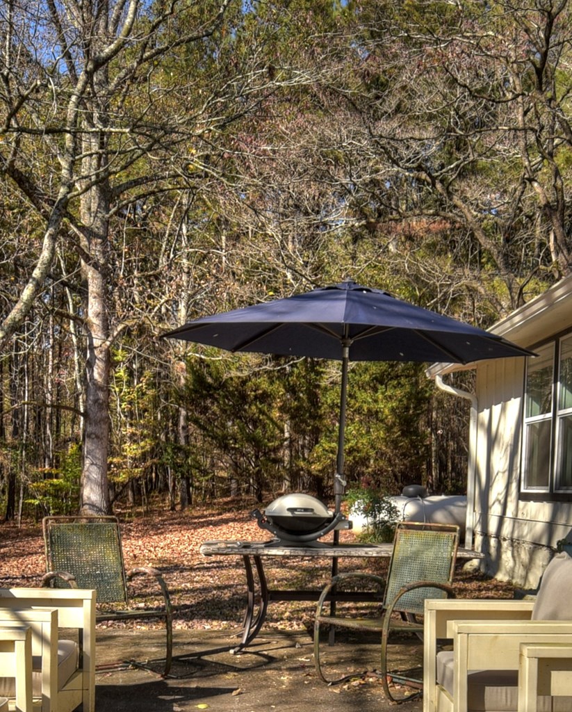 3380 Clear Creek Road Ellijay, GA 30536 - Photo 10 of 39 a view of a patio with table and chairs under an umbrella