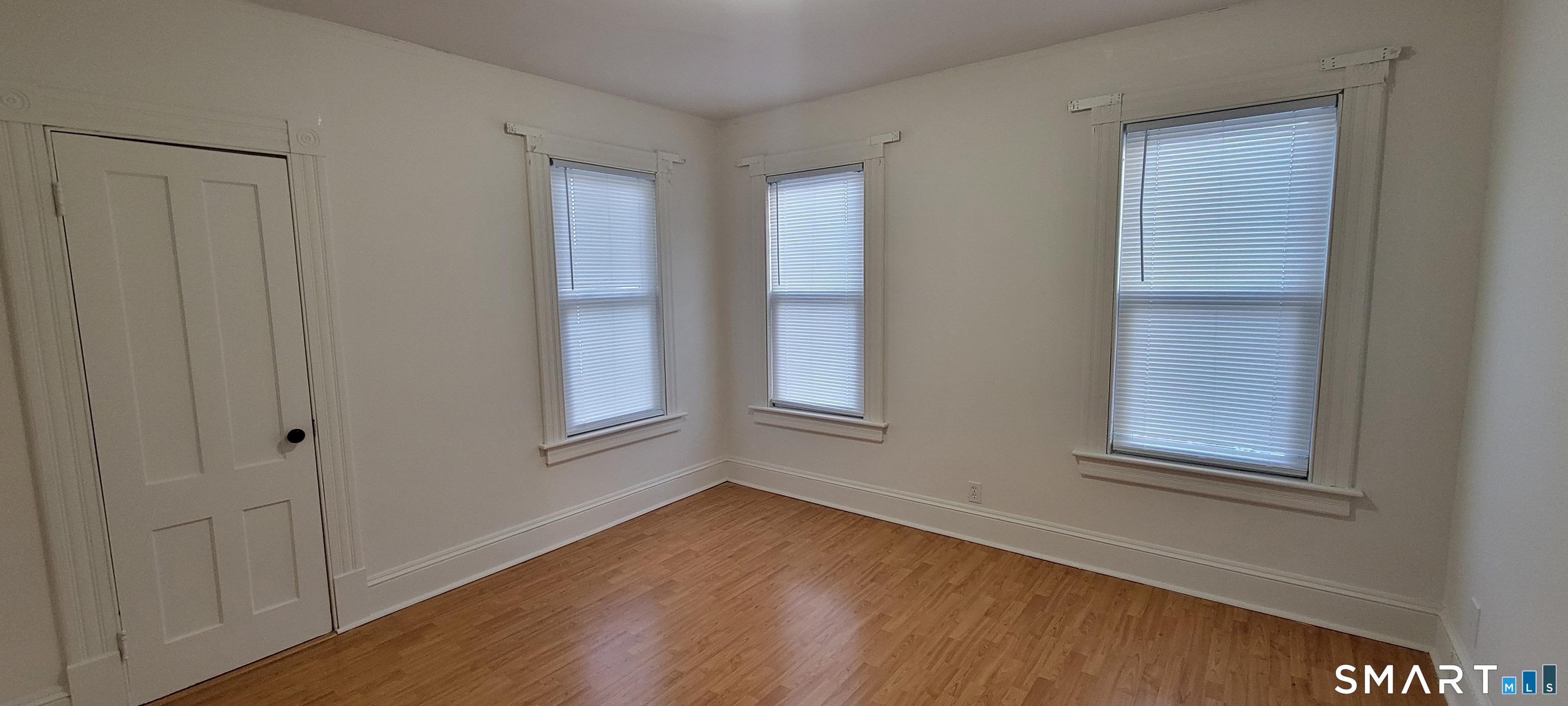 130 Church Street Bristol, CT 06010 - Photo 15 of 22 a view of an empty room with wooden floor and a window