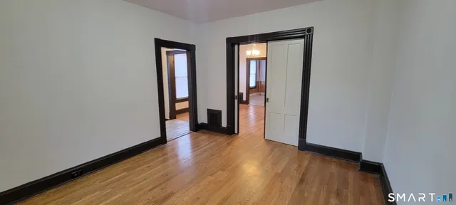 a view of a hallway with wooden floor