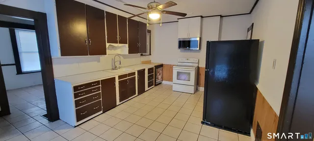 a kitchen with stainless steel appliances a refrigerator and a stove