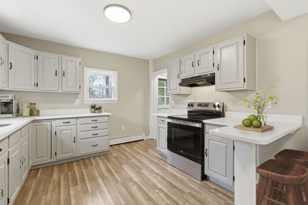 17 West High Street Erving, MA 01344 - Photo 3 of 12 a kitchen with white cabinets and appliances