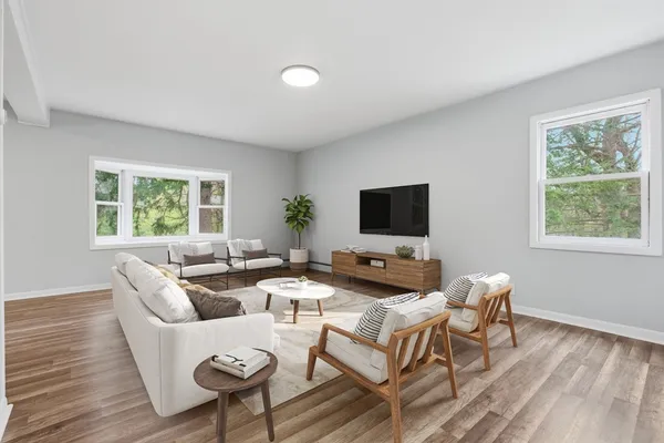 a living room with couches and a flat screen tv