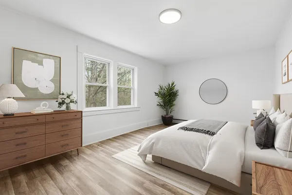 a bedroom with a bed and window with mirror