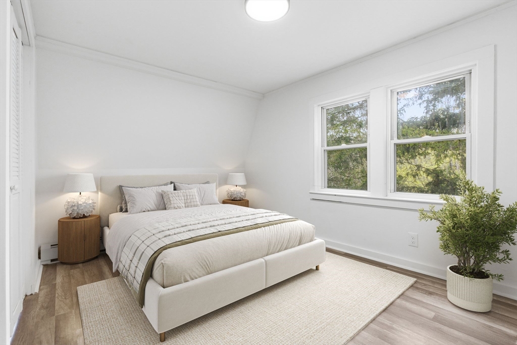 17 West High Street Erving, MA 01344 - Photo 9 of 12 a bedroom with a large bed and a potted plant