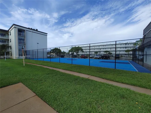 a view of yard with swimming pool and green space
