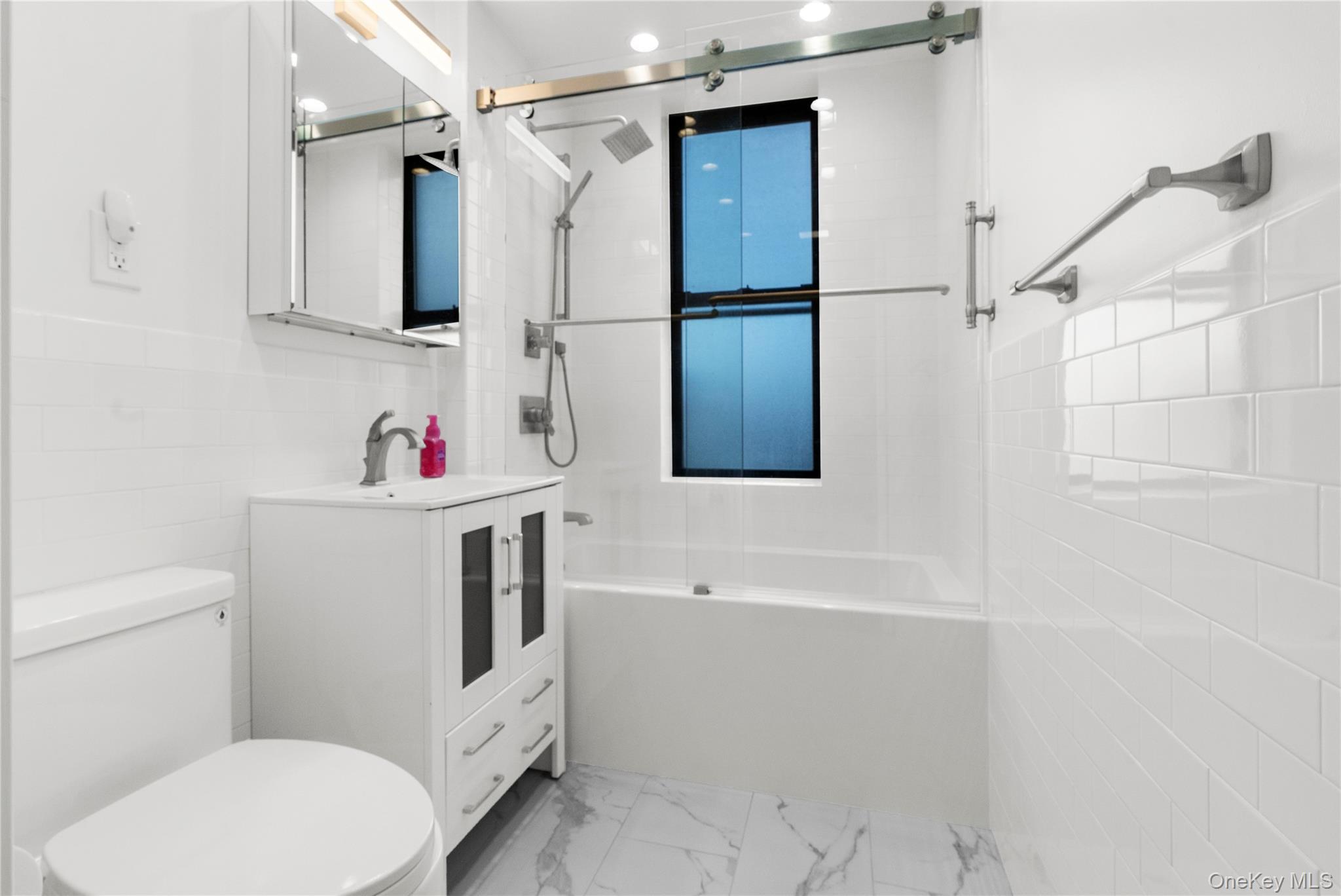 37 Brompton Road, Unit 3D Great Neck, NY 11021 - Photo 14 of 18 a bathroom with a sink toilet and shower