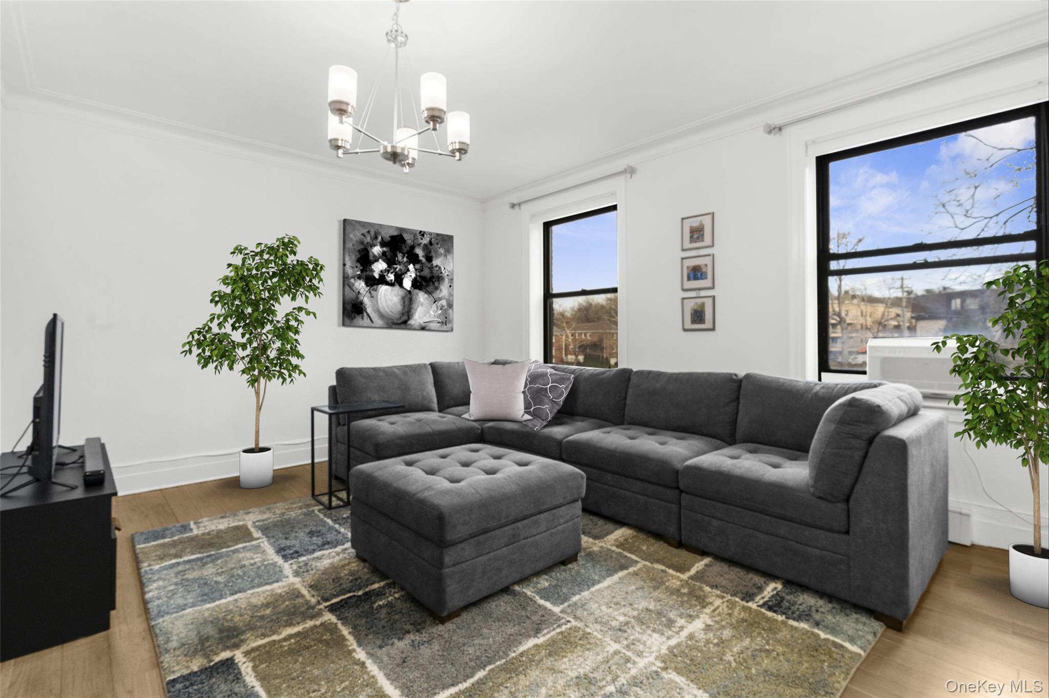37 Brompton Road, Unit 3D Great Neck, NY 11021 - Photo 6 of 18 a living room with furniture a chandelier and a window