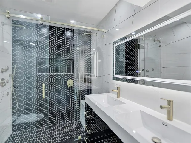 a bathroom with a sink and mirror