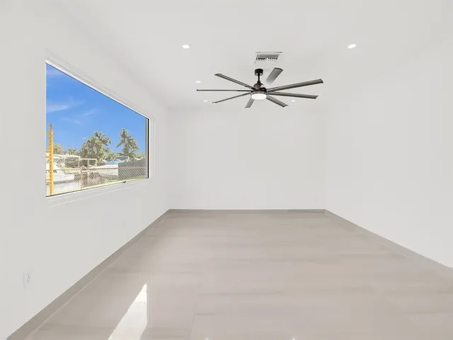 an empty room with floor to ceiling windows