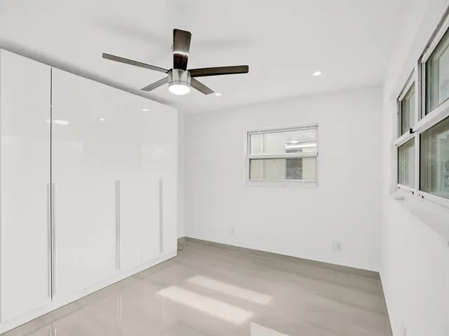 a view of an empty room with a ceiling fan