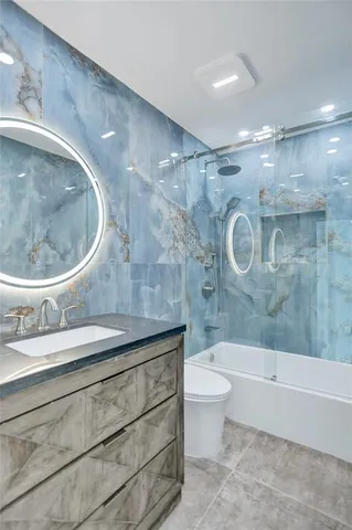 a bathroom with a sink a toilet and bathtub