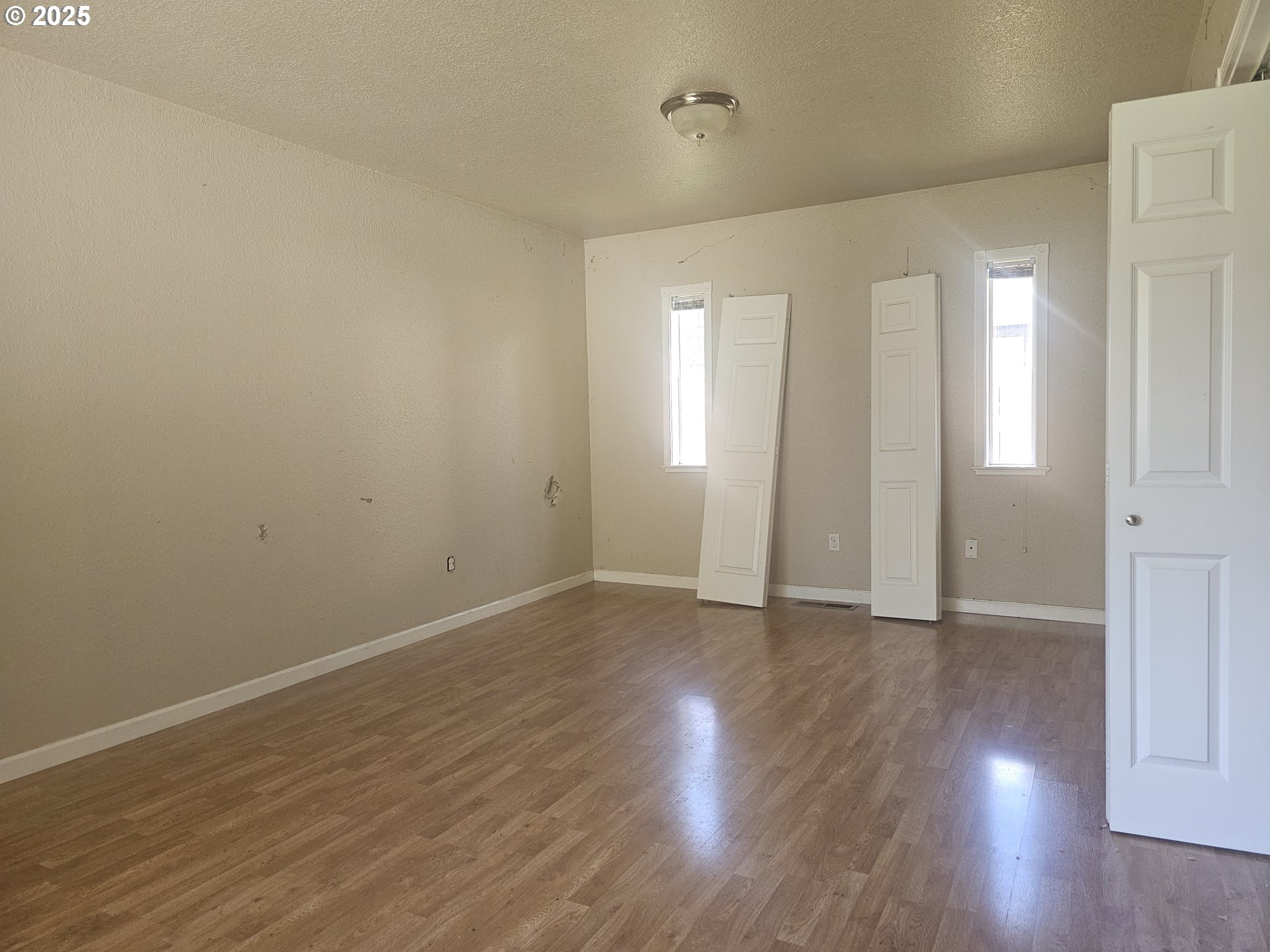 183 East Dodge Street Lebanon, OR 97355 - Photo 11 of 21 a view of an empty room with wooden floor