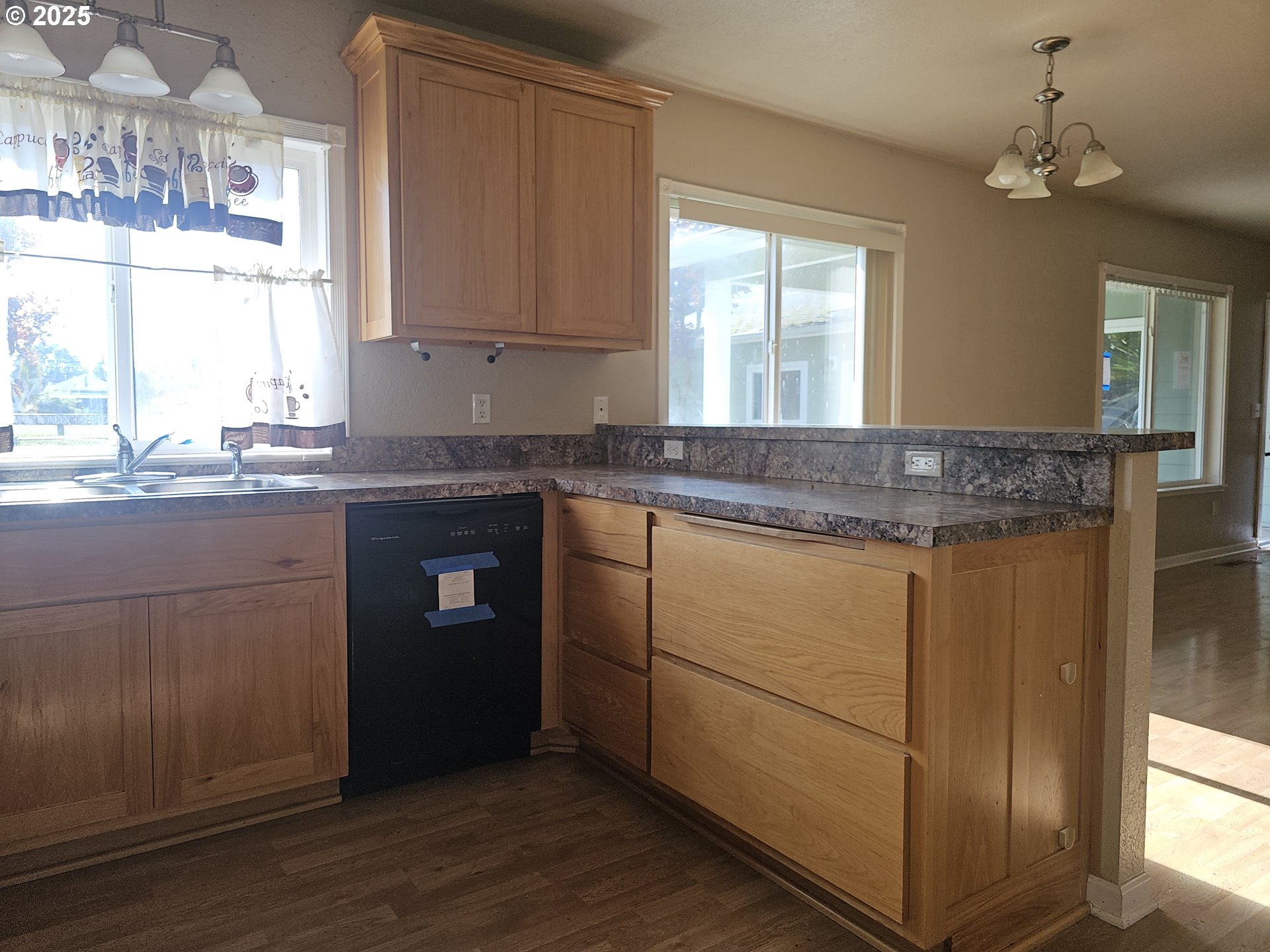 183 East Dodge Street Lebanon, OR 97355 - Photo 5 of 21 a kitchen with granite countertop cabinets stainless steel appliances and a window