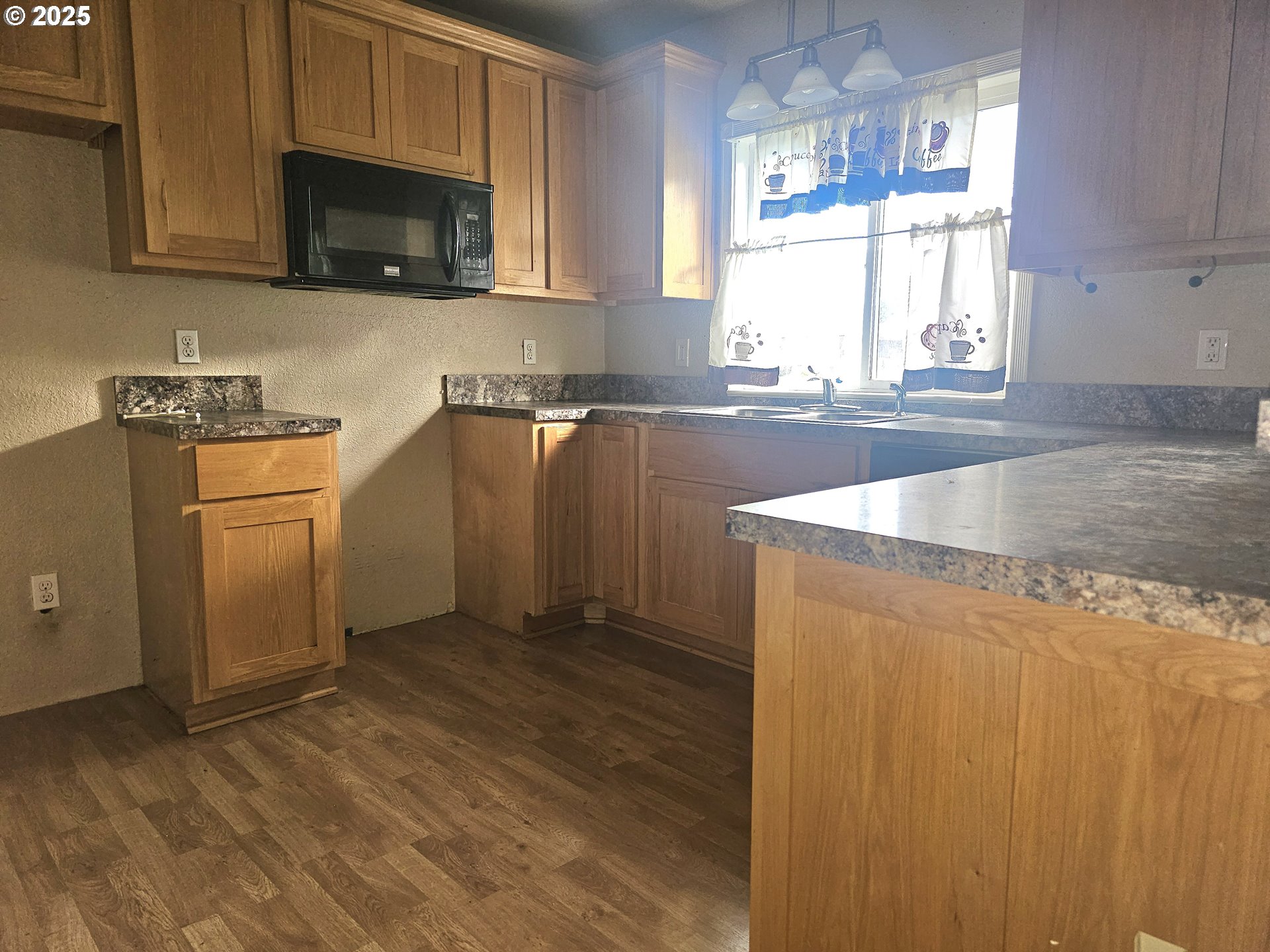 183 East Dodge Street Lebanon, OR 97355 - Photo 6 of 21 a kitchen with stainless steel appliances granite countertop a sink a stove a microwave a counter space and cabinets