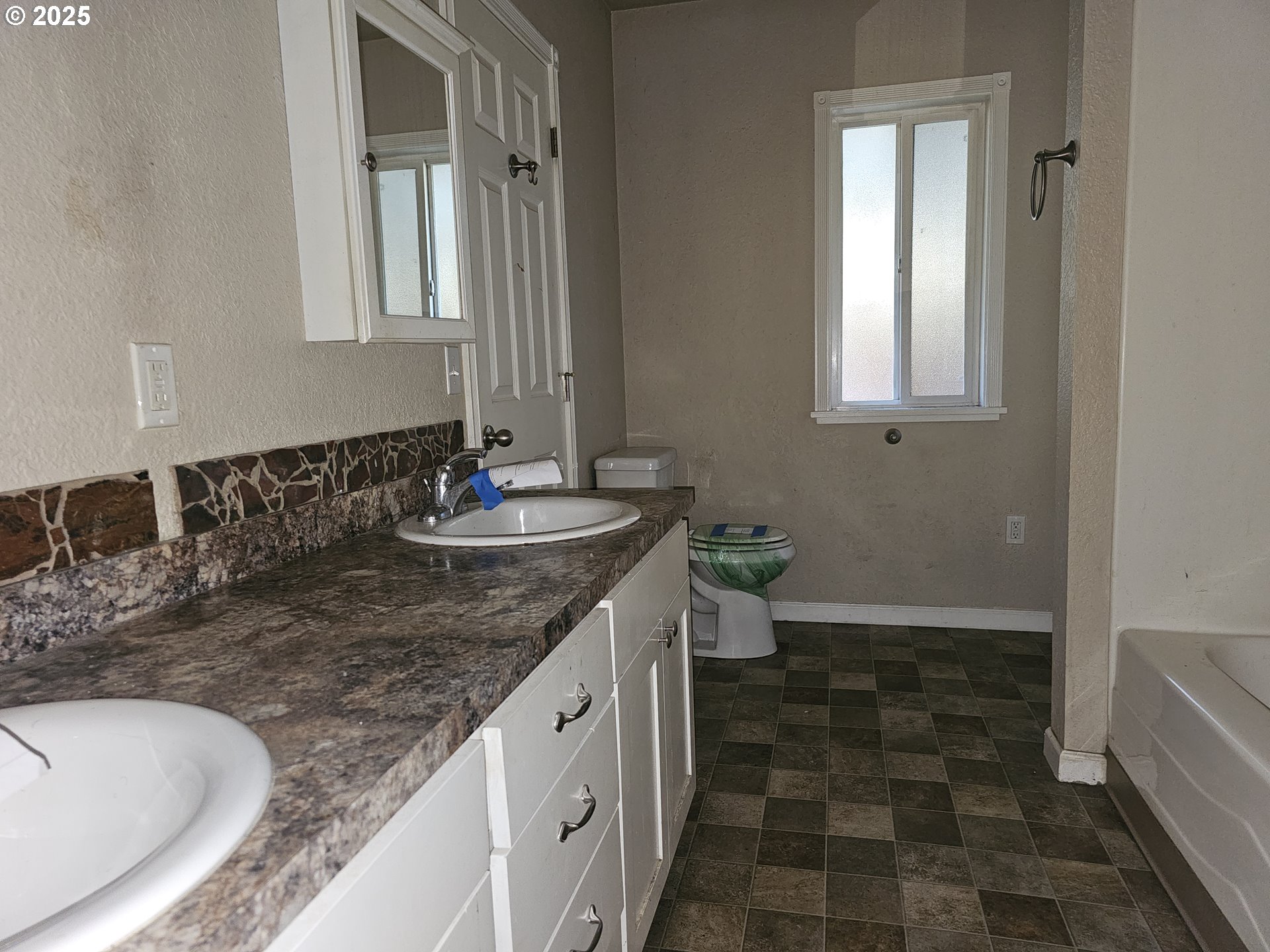 183 East Dodge Street Lebanon, OR 97355 - Photo 9 of 21 a bathroom with a granite countertop sink a toilet and a mirror