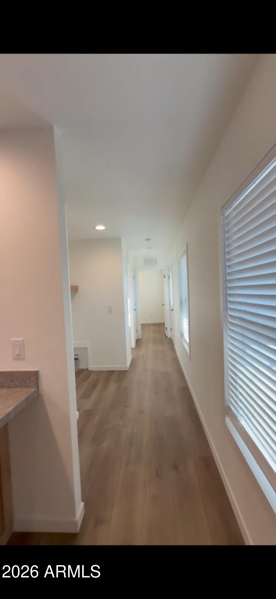 5201 West Camelback Road, Unit FP214 Phoenix, AZ 85031 - Photo 7 of 15 a view of a big room with wooden floor