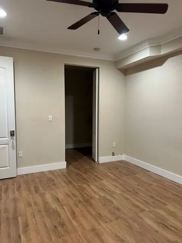 an empty room with wooden floor