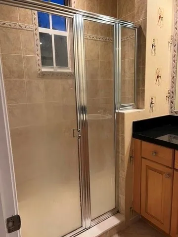 a bathroom with a shower and a sink