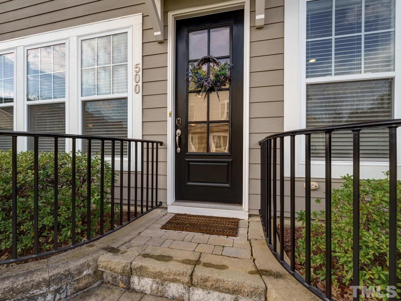 500 Deodar Lane Raleigh, NC 27608 - Photo 1 of 49 a view of a balcony with a floor to ceiling window and wooden fence