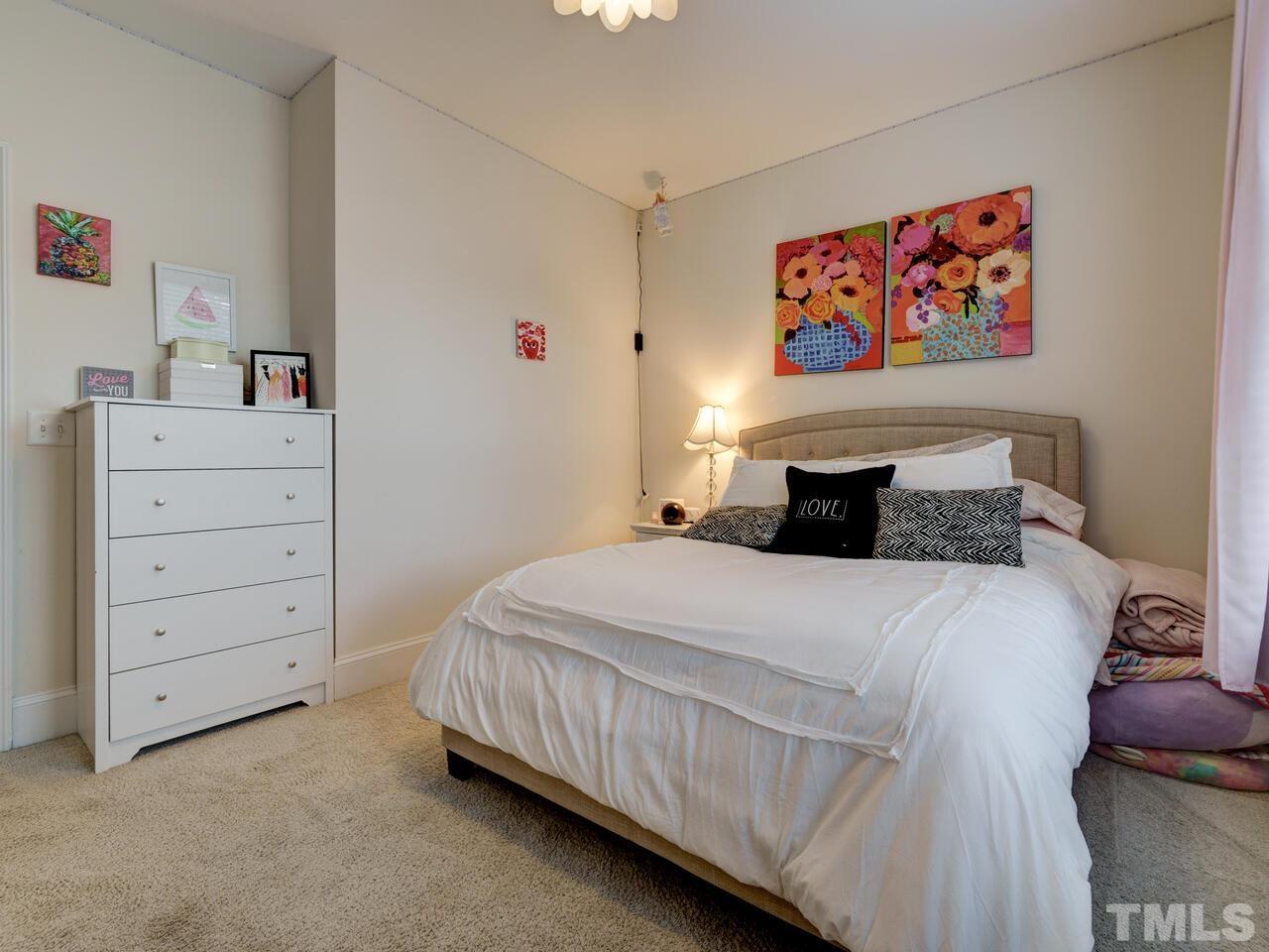 500 Deodar Lane Raleigh, NC 27608 - Photo 25 of 49 a bedroom with a bed and dresser