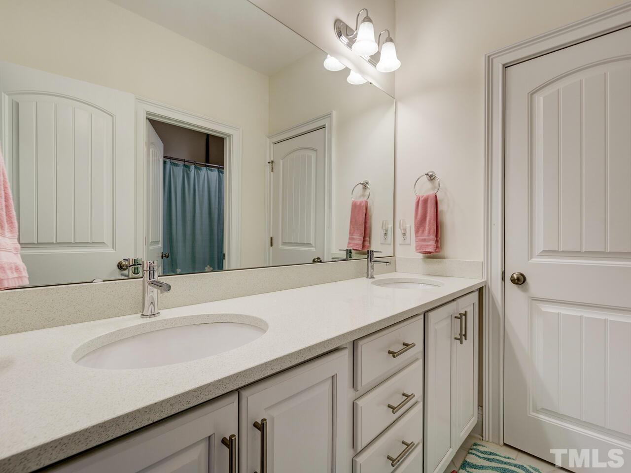500 Deodar Lane Raleigh, NC 27608 - Photo 26 of 49 a bathroom with a sink and a mirror