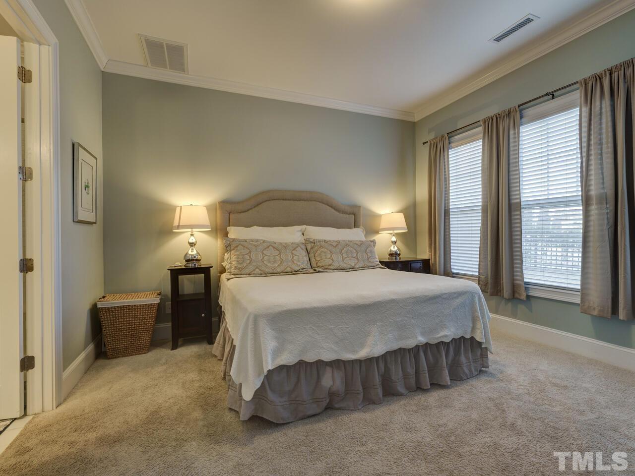 500 Deodar Lane Raleigh, NC 27608 - Photo 38 of 49 a bedroom with a bed and wooden floor