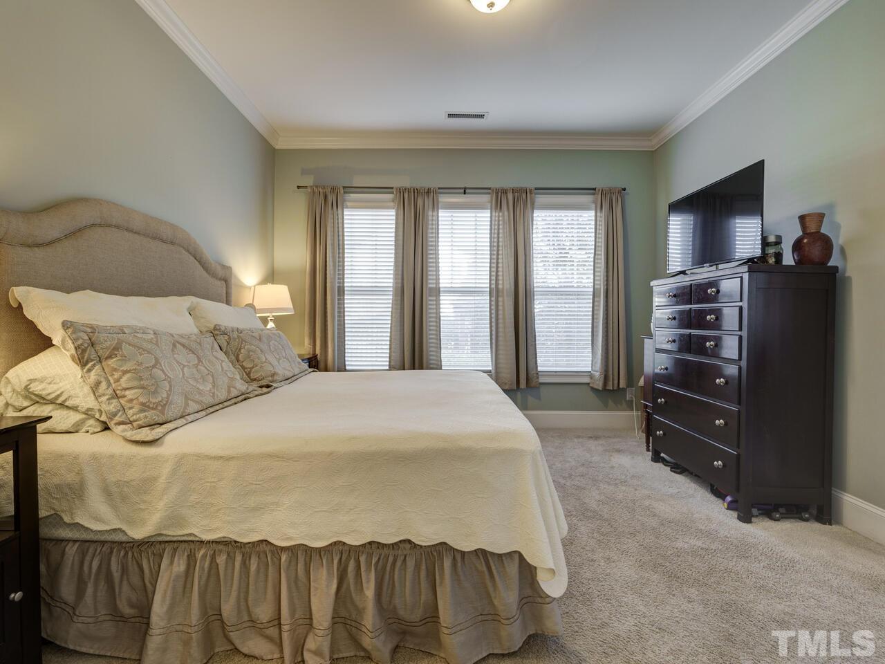 500 Deodar Lane Raleigh, NC 27608 - Photo 39 of 49 a bedroom with a bed and dresser