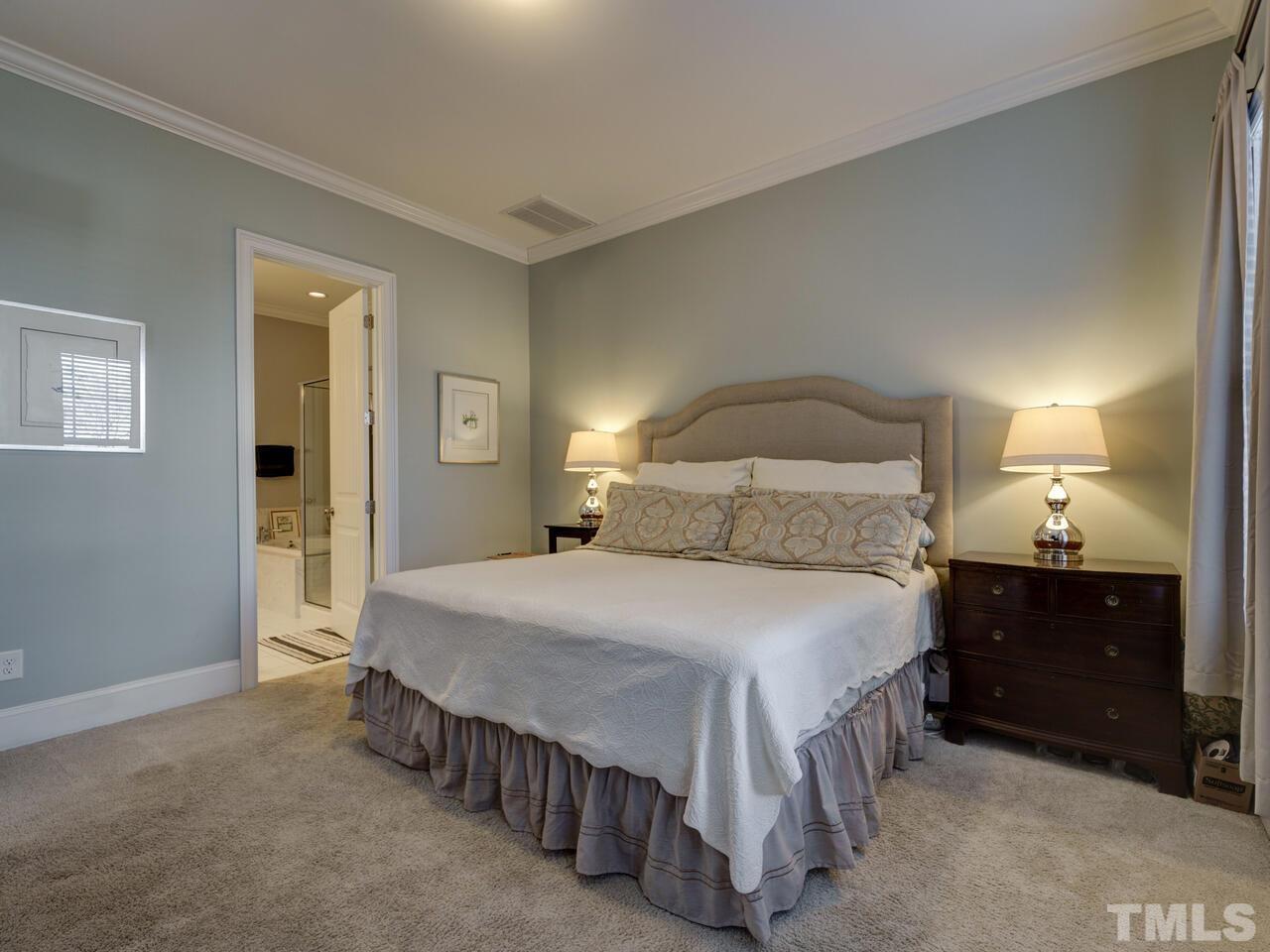 500 Deodar Lane Raleigh, NC 27608 - Photo 40 of 49 a bedroom with a bed and lamp on dresser
