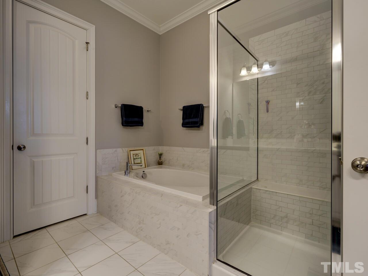 500 Deodar Lane Raleigh, NC 27608 - Photo 42 of 49 a bathroom with a bathtub and a shower