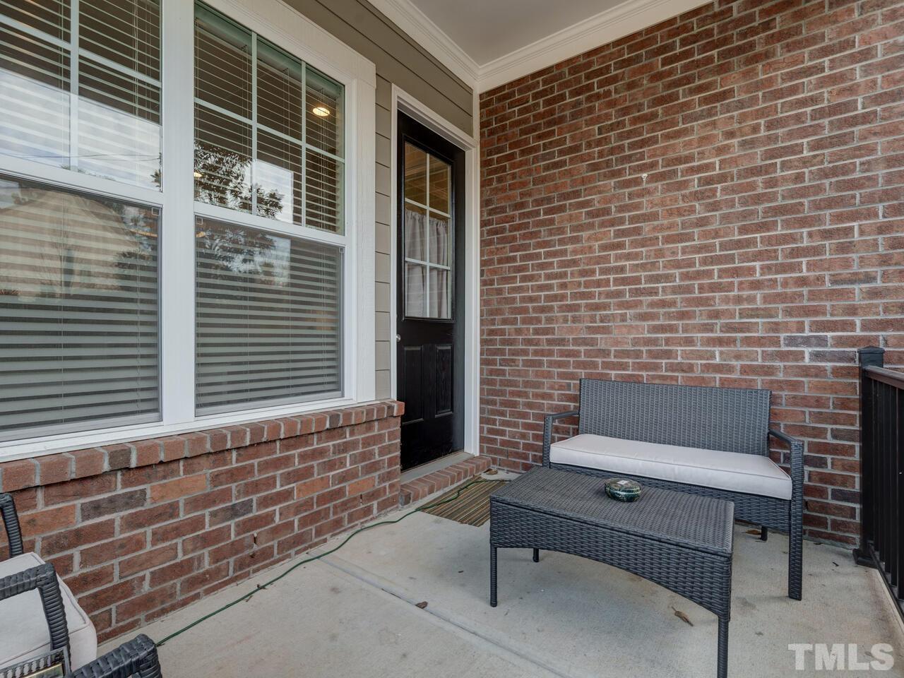 500 Deodar Lane Raleigh, NC 27608 - Photo 43 of 49 a brick building with a bench in front of door