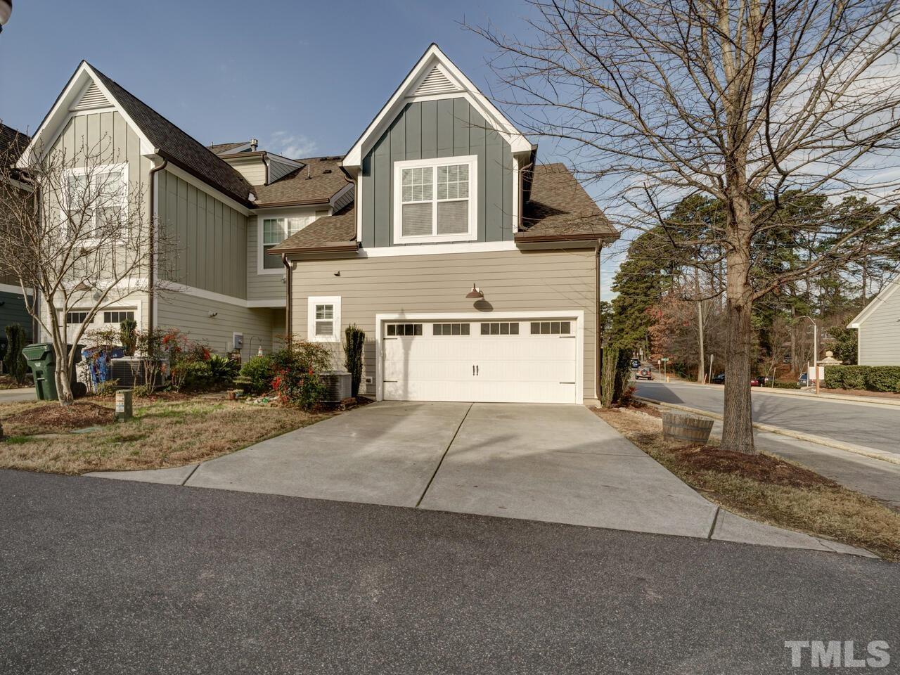 500 Deodar Lane Raleigh, NC 27608 - Photo 46 of 49 a front view of a house with a yard and garage