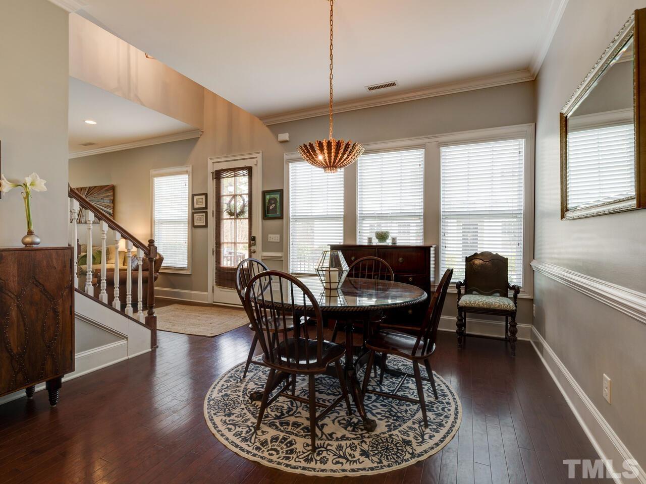 500 Deodar Lane Raleigh, NC 27608 - Photo 5 of 49 a dining room with furniture a chandelier and wooden floor