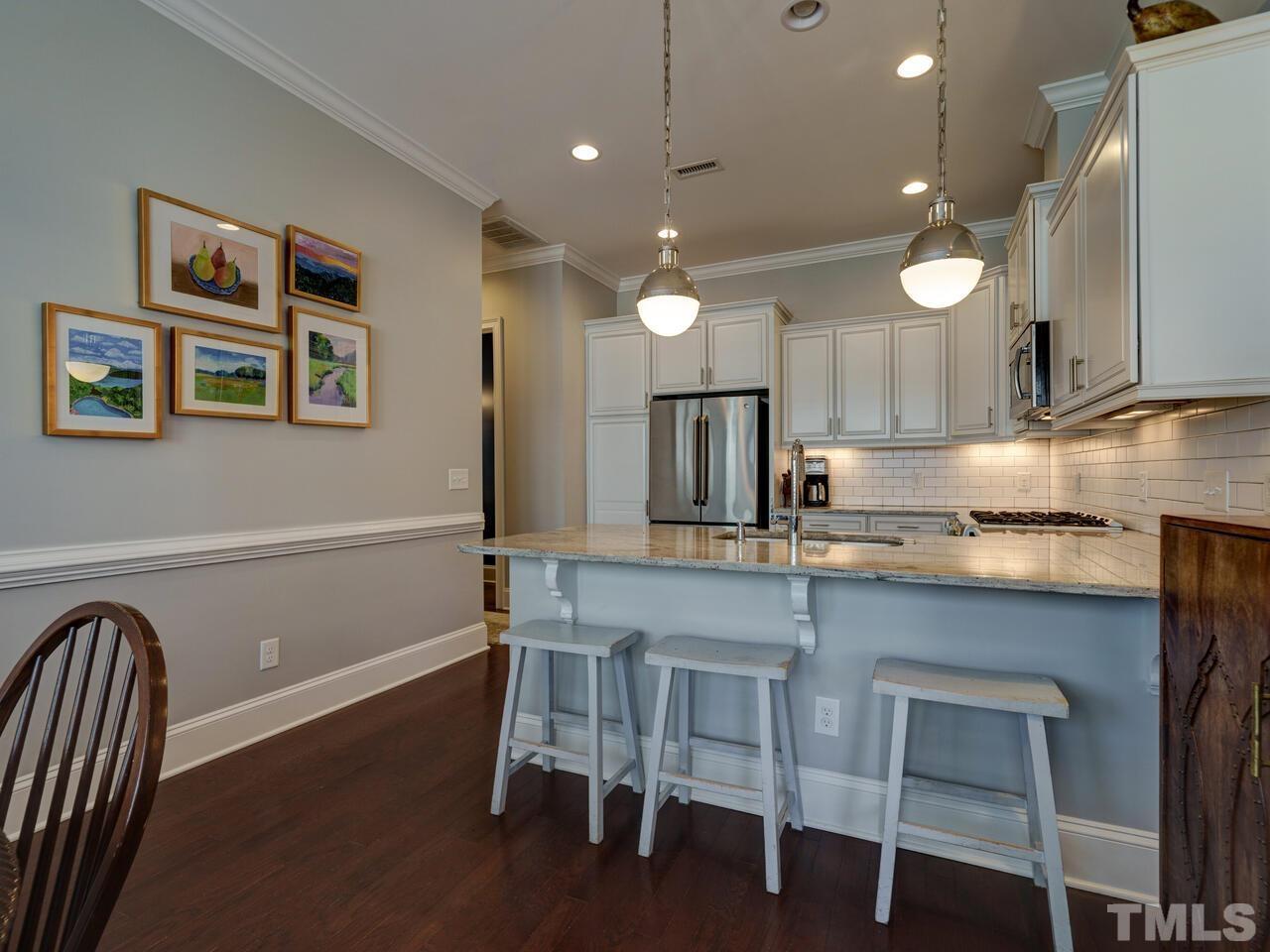 500 Deodar Lane Raleigh, NC 27608 - Photo 7 of 49 a kitchen with cabinets table and chairs