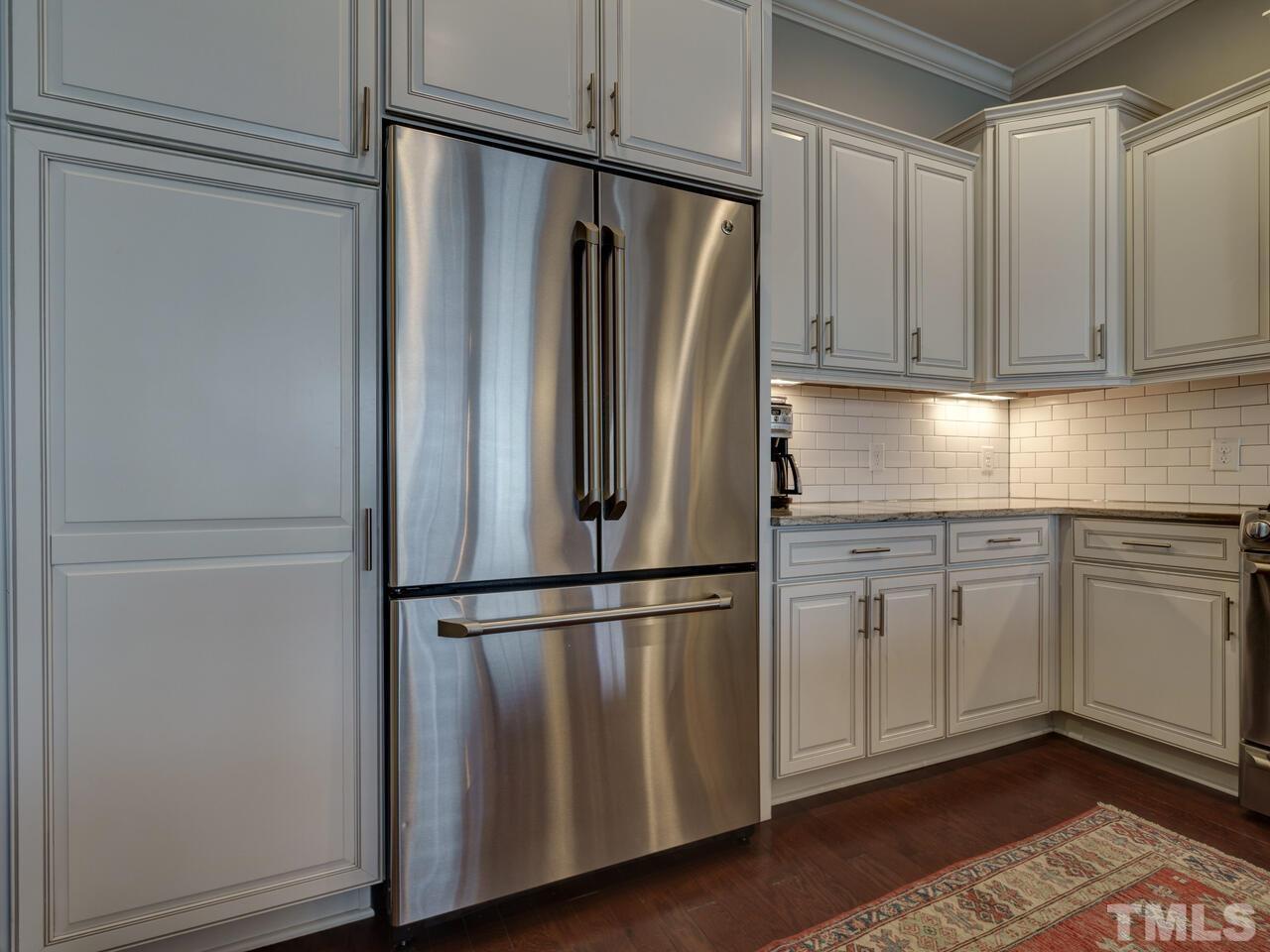 500 Deodar Lane Raleigh, NC 27608 - Photo 8 of 49 a kitchen with stainless steel appliances granite countertop a refrigerator sink and cabinets