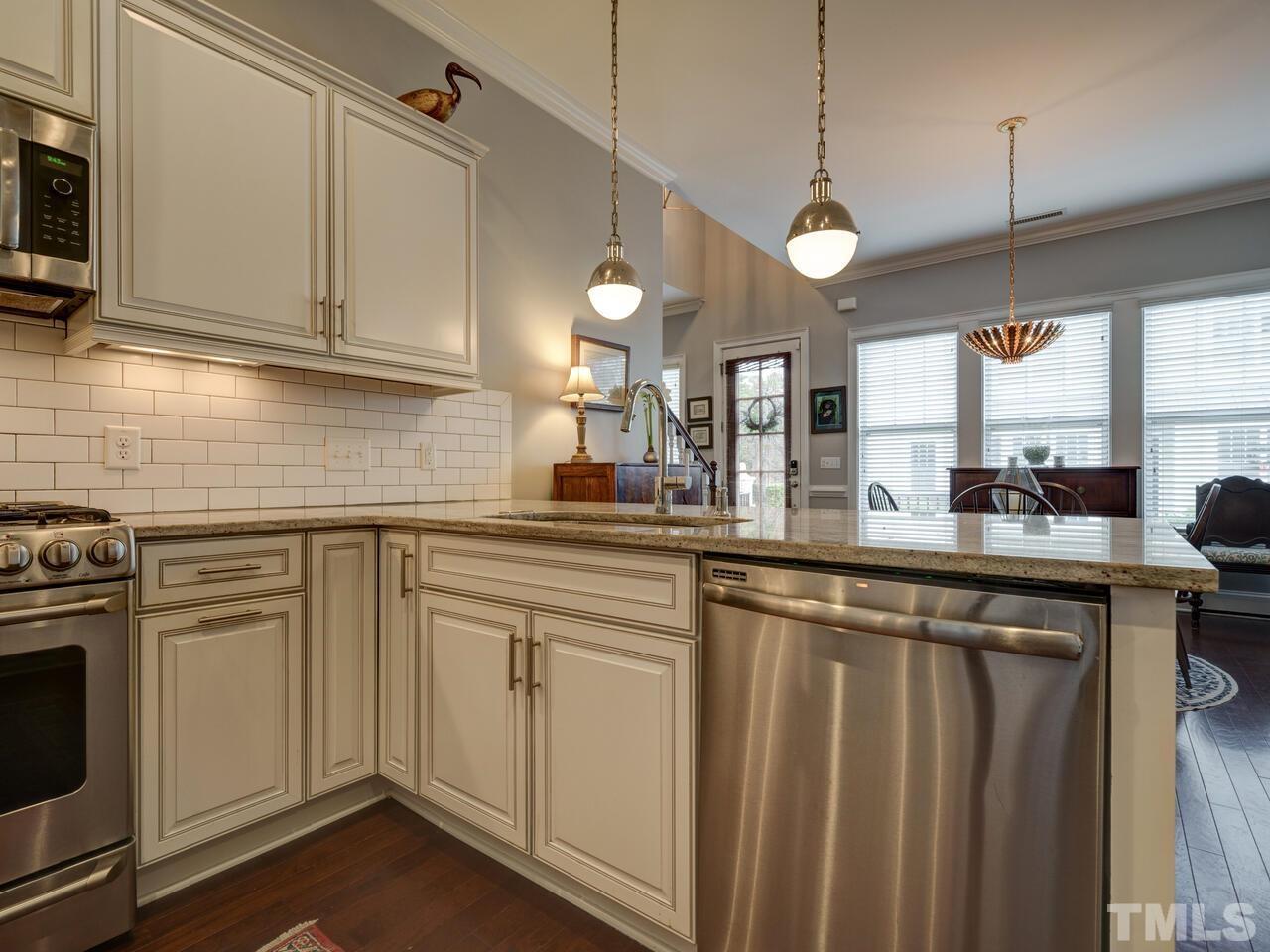500 Deodar Lane Raleigh, NC 27608 - Photo 10 of 49 a kitchen with stainless steel appliances granite countertop a sink a stove and a microwave