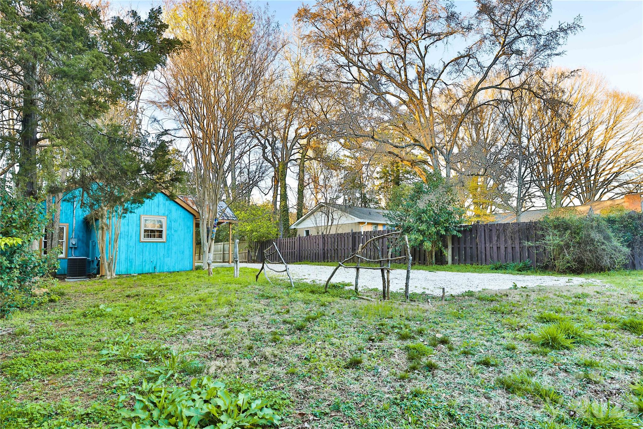 221 Pineville-Matthews Road Matthews, NC 28105 - Photo 25 of 29 a view of a house with a yard and a bench