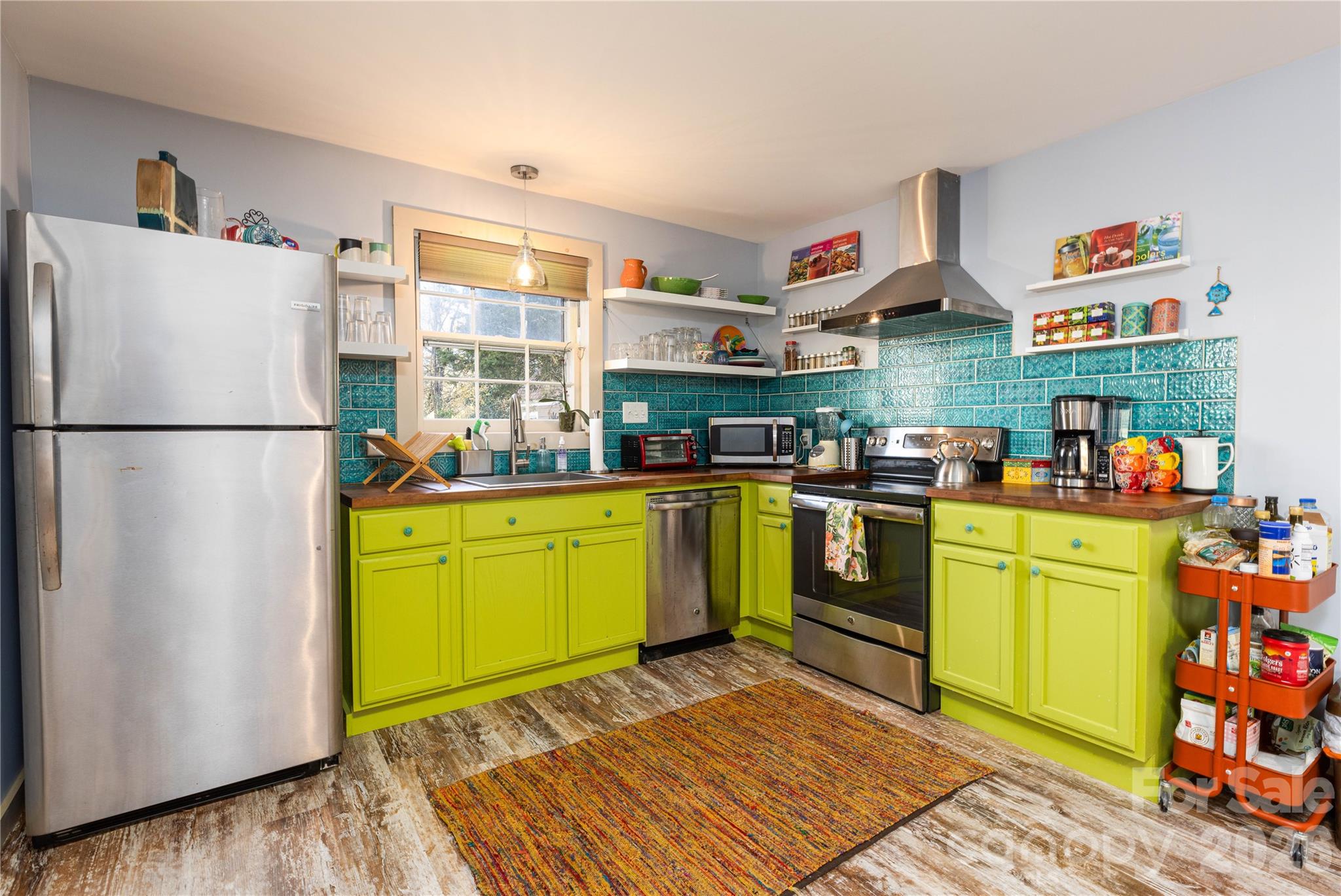 221 Pineville-Matthews Road Matthews, NC 28105 - Photo 6 of 29 a kitchen with a refrigerator and a stove top oven