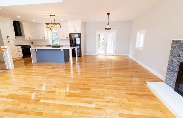 171 Hamilton Street Saugus, MA 01906 - Photo 3 of 42 a view of a kitchen with kitchen island dining table and wooden floor
