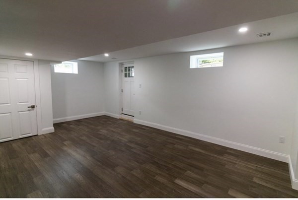 171 Hamilton Street Saugus, MA 01906 - Photo 39 of 42 an empty room with wooden floor and windows