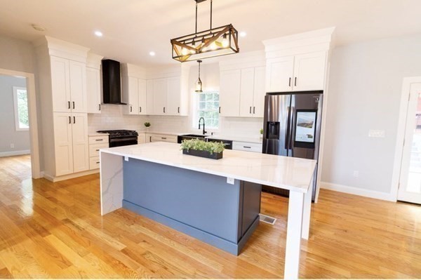 171 Hamilton Street Saugus, MA 01906 - Photo 7 of 42 a kitchen with stainless steel appliances a stove a refrigerator and cabinets