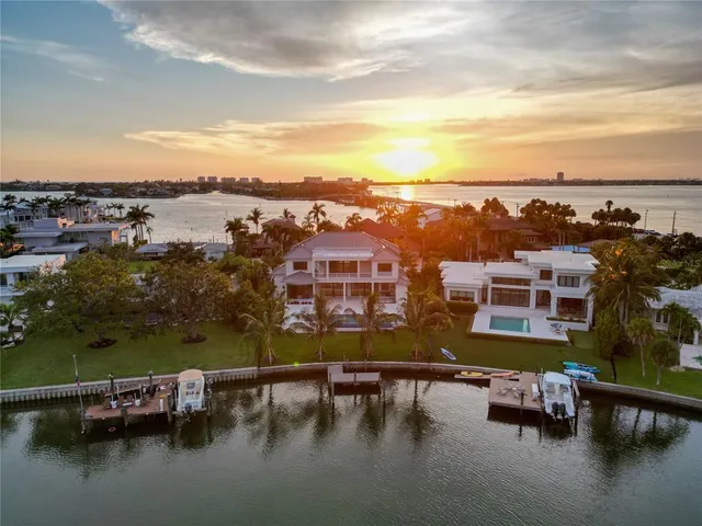 a front view of a house with a yard and potted plants