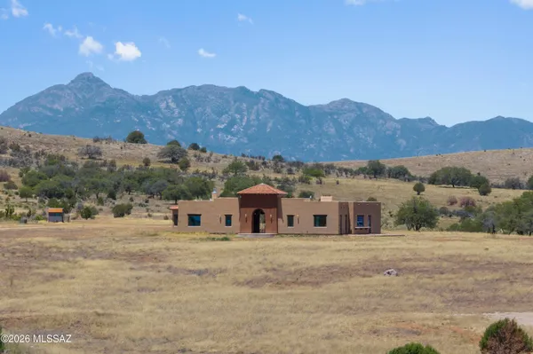 a view of a house with a mountain yard