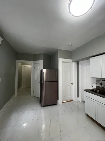 a kitchen with a refrigerator and a stove top oven
