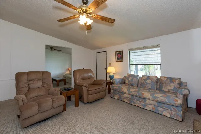 a living room with couches and a chandelier