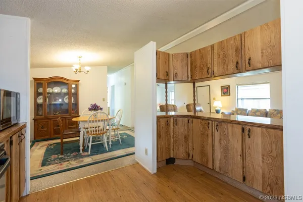 a kitchen with stainless steel appliances a refrigerator and wooden cabinets
