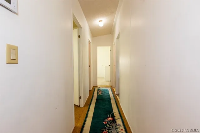 a bedroom with a bed chandelier and a window