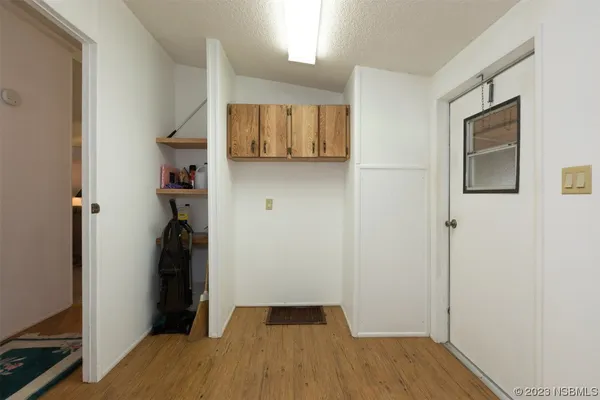 a view of a room with wooden floor and cabinet